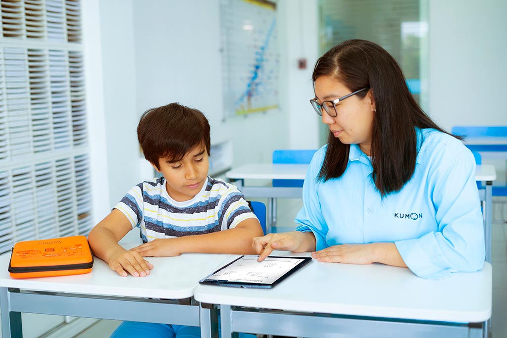 Alumno recibiendo orientación después de finalizar la tarea realizada en la tablet